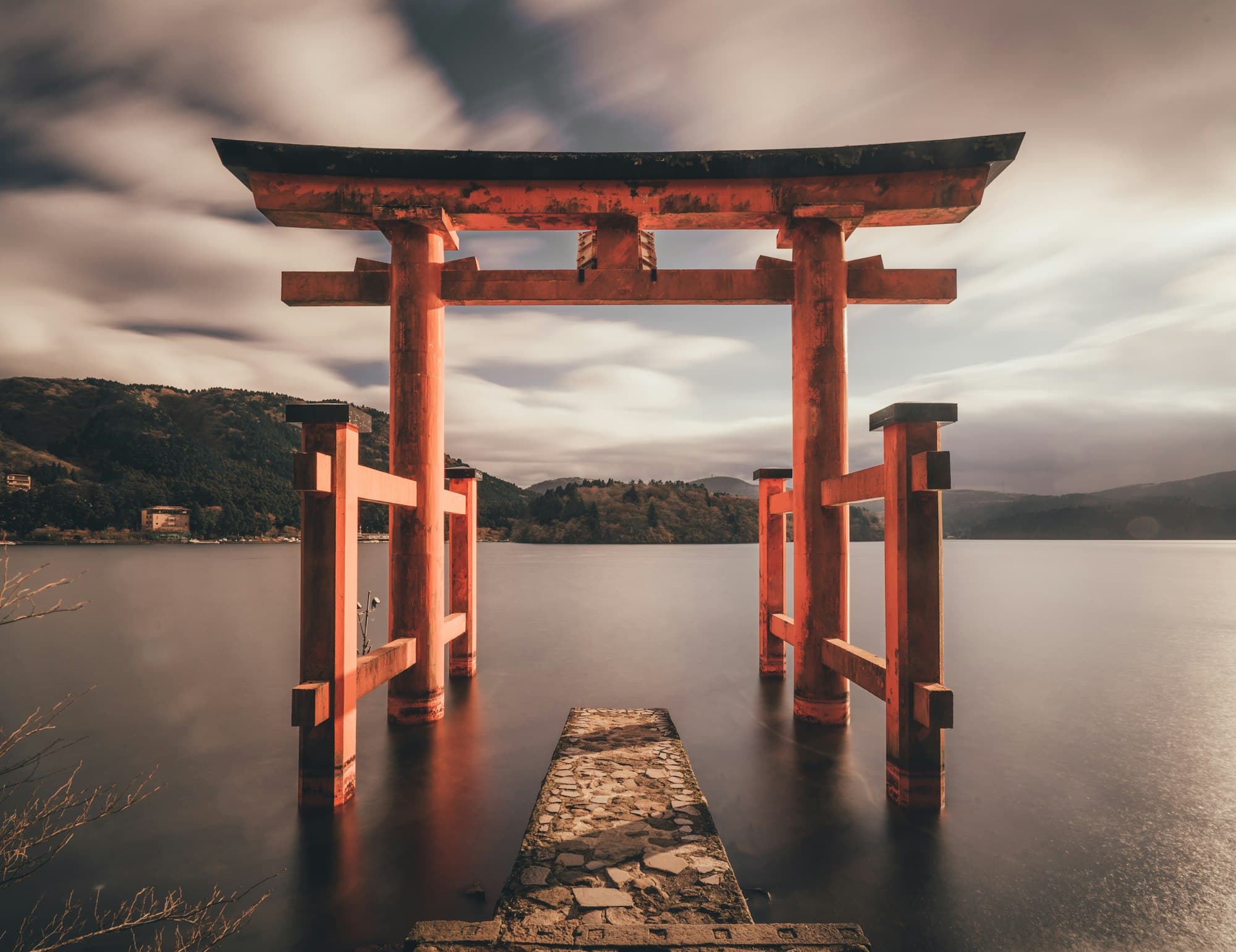 A traditional five-storied Japanese pagoda framed by cherry blossoms in spring